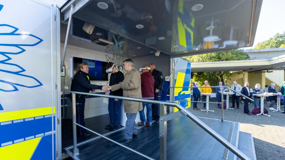 NRW-Innenminister Reul begrüßt Polizisten an deren Infostand